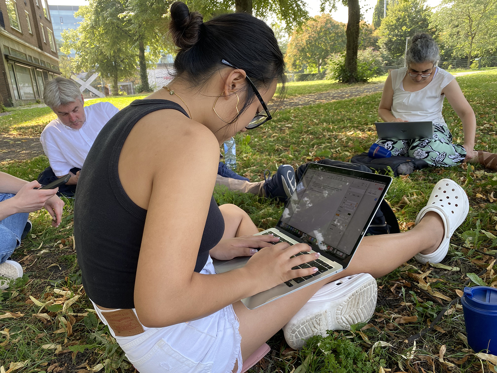 individual writings in the park on a hot summer's day